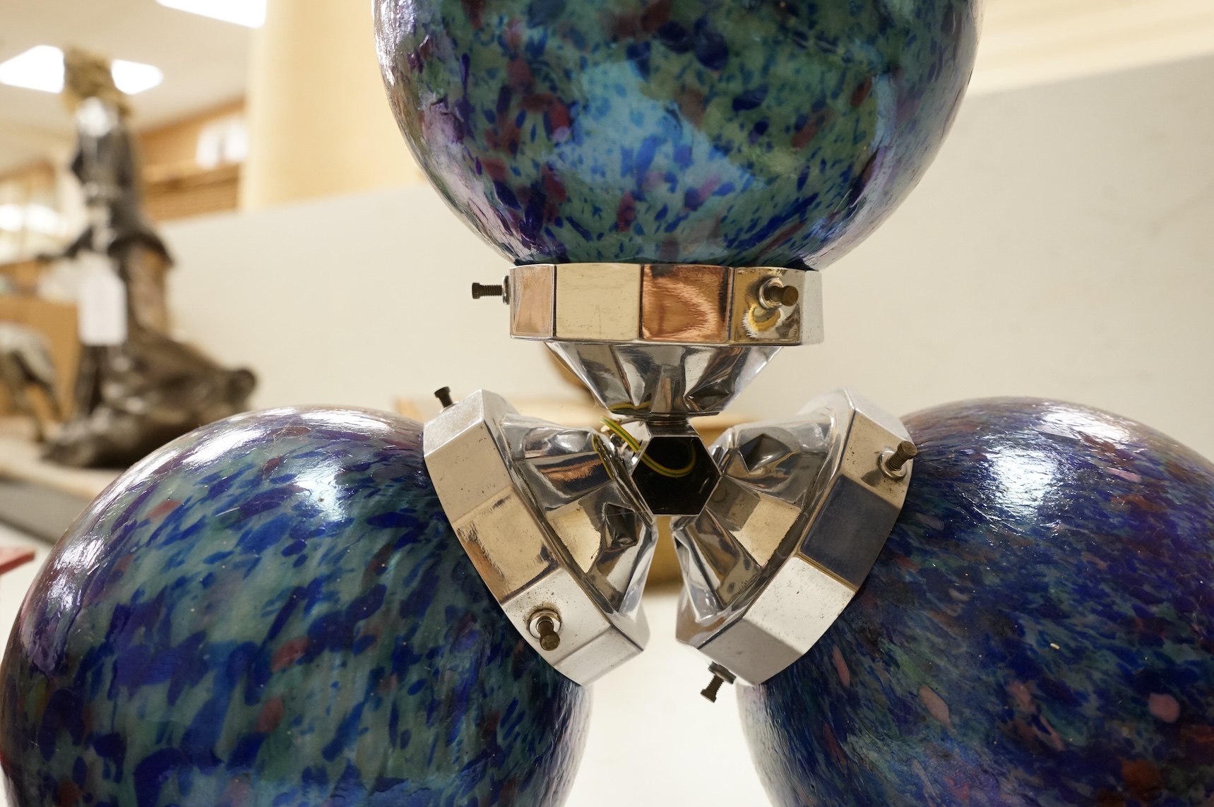 A French Art Deco chromed metal triple glass globed pendant ceiling light, 63cm high